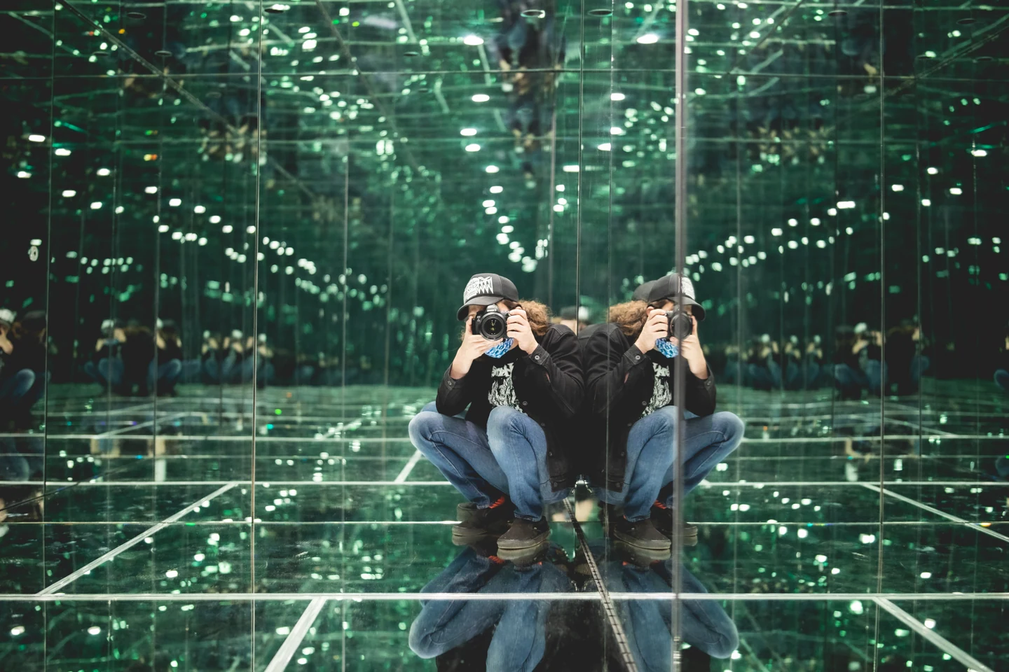 Mirrored Inception Cube interior with green points of light
